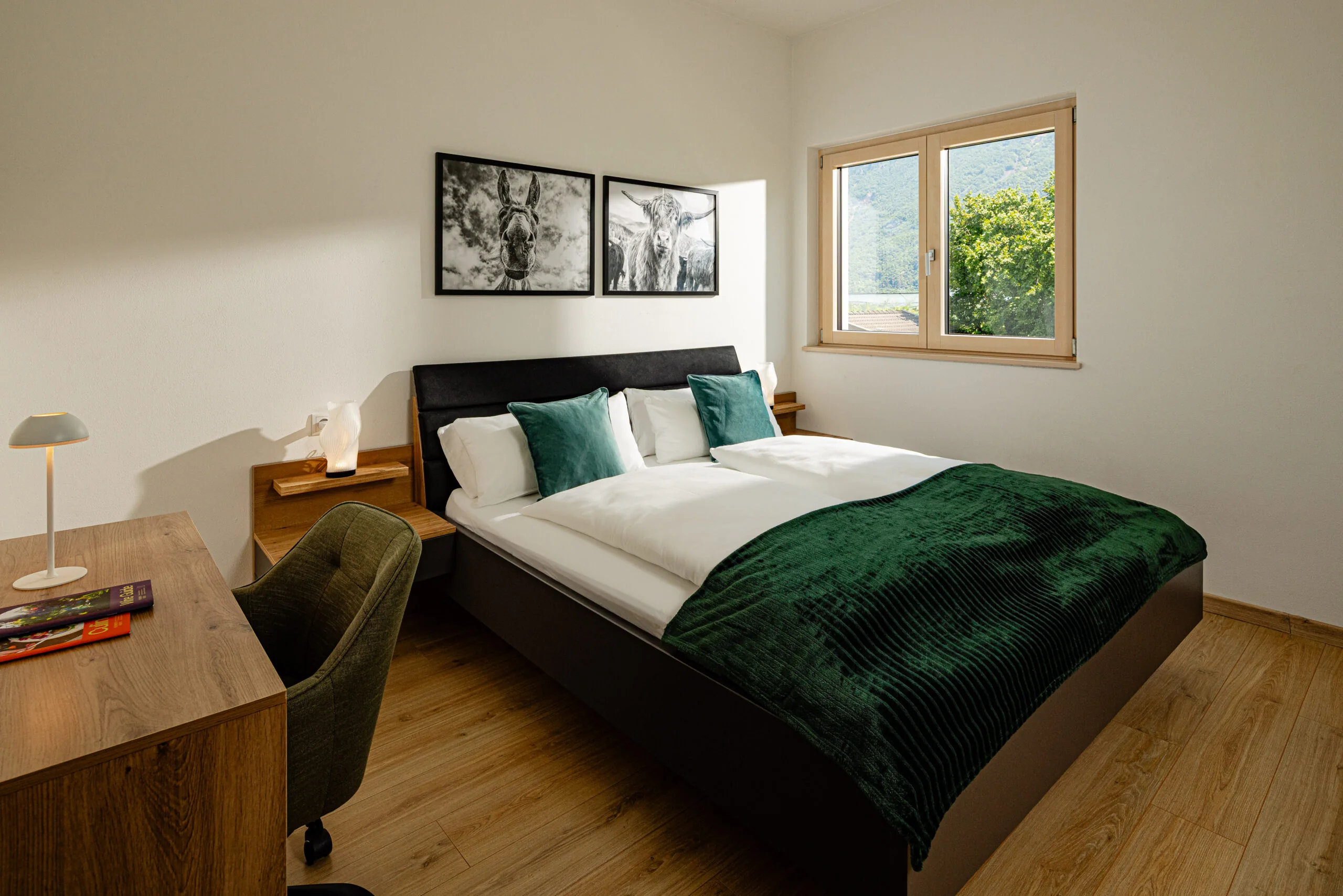Bedroom with a king-size bed and green throw