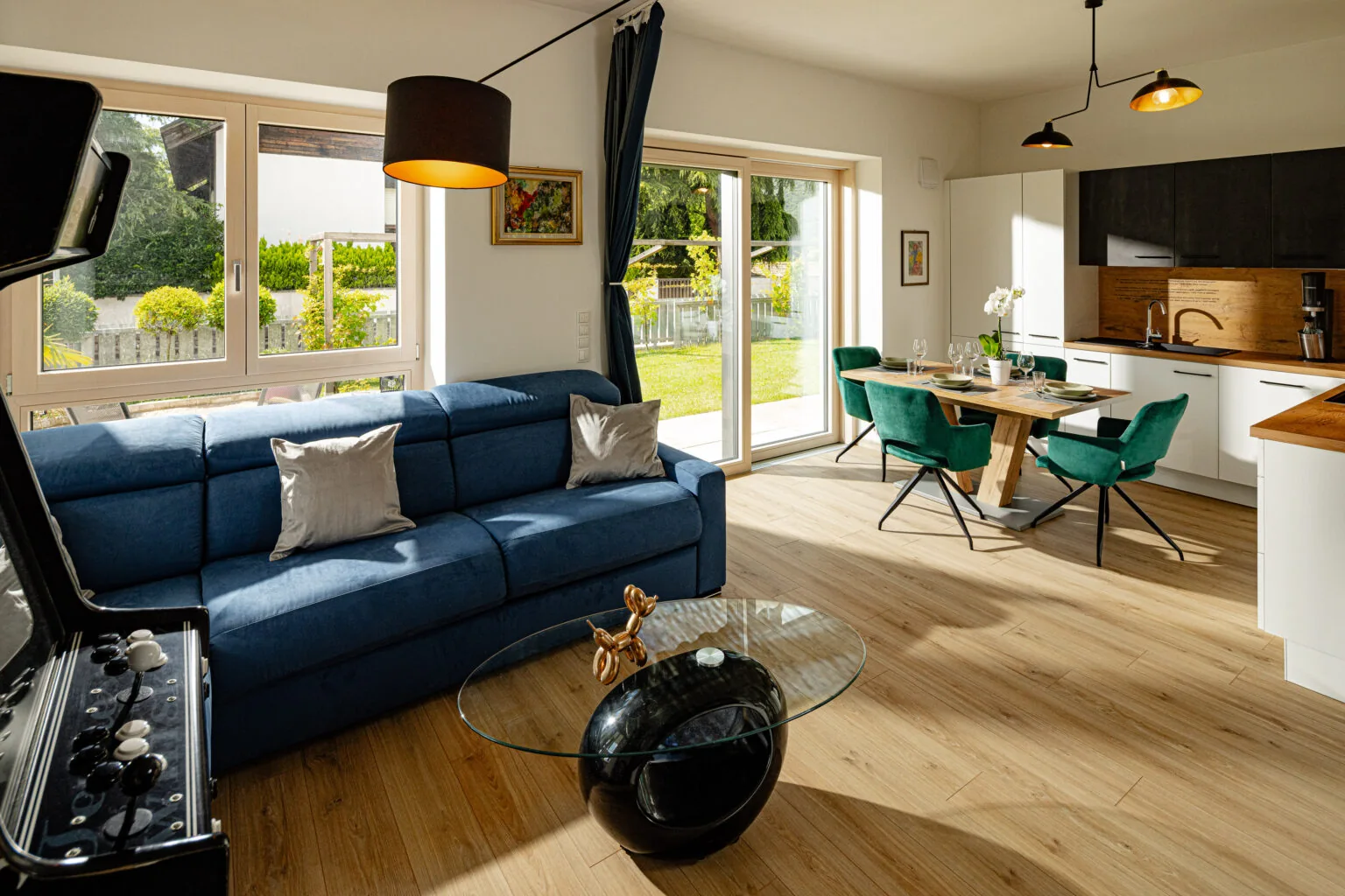 Bright living room with a blue sofa and dining area